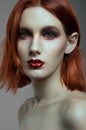 Young red-haired woman with colorful make up