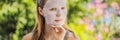 Young red-haired woman doing facial mask sheet. Beauty and Skin Care Concept BANNER, LONG FORMAT Royalty Free Stock Photo