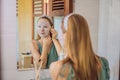 Young red-haired woman doing facial mask sheet. Beauty and Skin Care Concept Royalty Free Stock Photo