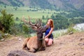 A young red-haired woman dressed in sports clothes stroking the Royalty Free Stock Photo