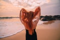 Young red-haired woman with flying hair on the ocean, rear view Royalty Free Stock Photo