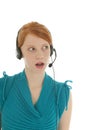 Young red haired woman with head set listening Royalty Free Stock Photo