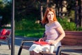 A young red-haired woman in park Royalty Free Stock Photo