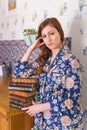 Young red-haired woman relaxing at home with books. Quarantine, isolation, coronavirus pandemic world. Stay at home. Royalty Free Stock Photo