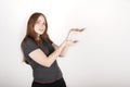 Young red haired woman wearing a grey shirt over isolated white background smiling at the camera while presenting with her hands Royalty Free Stock Photo