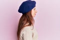 Young red head girl wearing french look with beret looking to side, relax profile pose with natural face with confident smile Royalty Free Stock Photo