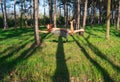 Young Red head woman levitating in the Pine forest