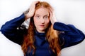 Young redhaired woman holding her head Royalty Free Stock Photo