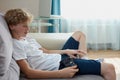 Young redhead boy play video games at home Royalty Free Stock Photo