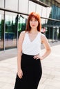 Young redhead business woman in formal outside