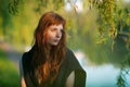 Young redhead caucasian woman serious face outdoor portrait in film retro colors