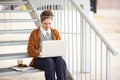 Young redhead hipster woman student using computer outdoors Royalty Free Stock Photo