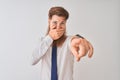 Young redhead irish businessman standing over isolated white background laughing at you, pointing finger to the camera with hand Royalty Free Stock Photo