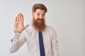 Young redhead irish businessman standing over isolated white background Waiving saying hello happy and smiling, friendly welcome Royalty Free Stock Photo