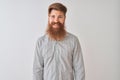 Young redhead irish man wearing casual shirt standing over isolated white background with a happy and cool smile on face Royalty Free Stock Photo