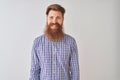 Young redhead irish man wearing casual shirt standing over isolated white background with a happy and cool smile on face Royalty Free Stock Photo