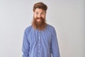 Young redhead irish man wearing casual shirt standing over isolated white background with a happy and cool smile on face Royalty Free Stock Photo
