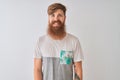 Young redhead irish man wearing t-shirt standing over isolated white background with a happy and cool smile on face Royalty Free Stock Photo