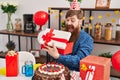 Young redhead man celebrating birthday unpacking gift at home Royalty Free Stock Photo