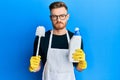 Young redhead man doing bathroom housework with toilet brush depressed and worry for distress, crying angry and afraid