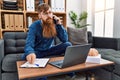 Young redhead man psychology having teleconsultation talking on the smarpthone at clinic Royalty Free Stock Photo