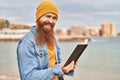 Young redhead man smiling confident reading book at seaside Royalty Free Stock Photo