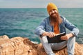 Young redhead man smiling confident reading book at seaside Royalty Free Stock Photo