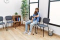 Young redhead man using crutches sitting on the chair at clinic waiting room Royalty Free Stock Photo