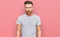 Young redhead man wearing casual grey t shirt making fish face with lips, crazy and comical gesture Royalty Free Stock Photo