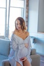 Young redhead pregnant woman in white clothes Royalty Free Stock Photo