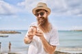 Young redhead tourist man smiling happy drinking cocktail at the beach Royalty Free Stock Photo