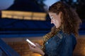 Young redhead woman reading funny message and laughing Royalty Free Stock Photo