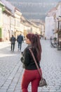 Young redhead walking in a pedestrian road in Brasov, Romania