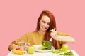 Comic grimacing funny woman on healthy food eating with broccoli and vegetables Royalty Free Stock Photo