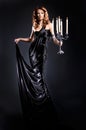 A young redhead woman in a dark long dress Royalty Free Stock Photo