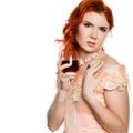 Young redhead woman drinks a red wine with a happy face and smiling with a confident smile. white background. free space Royalty Free Stock Photo