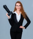 Young redhead woman holding a camera. Royalty Free Stock Photo