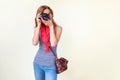 Young redhead woman looking through viewfinder with an old 35mm slr camera Royalty Free Stock Photo