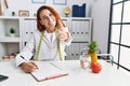 Young redhead woman nutritionist doctor at the clinic smiling friendly offering handshake as greeting and welcoming