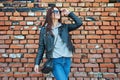 Young redhead woman posing near the brick wall Royalty Free Stock Photo