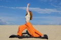 Young redhead woman practicing warrior pose from yoga on the beach Royalty Free Stock Photo