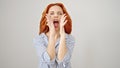 Young redhead woman screaming loudly over isolated white background Royalty Free Stock Photo