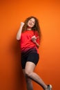 The young redhead woman in soccer football uniform having victiry mood as her team became winner, fan support concept. Royalty Free Stock Photo