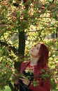 Young redhead woman standing in the cherry blossom Royalty Free Stock Photo