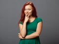 Young redhead woman in a thoughtful pose