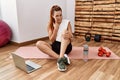 Young redhead woman watching training tutorial at the gym pointing to the eye watching you gesture, suspicious expression Royalty Free Stock Photo