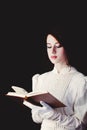 Woman in white Victorian era clothes with book Royalty Free Stock Photo