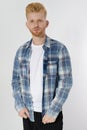 Young redheaded man with red beard in blank summer tshirt, plaid shirt isolated on white background. Unshaven confident serious Royalty Free Stock Photo