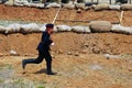 Young reenactor runs on the battle field