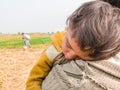 A young refugee child is sleeping on the shoulder of his father and both looks so tired hungry and terrified